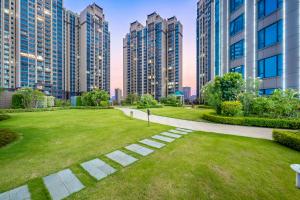 a park in a city with tall buildings at Evwa Platinum Hotel in Huizhou