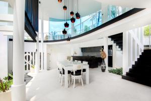 a dining room and kitchen with a glass ceiling at Villa Rose in Seminyak