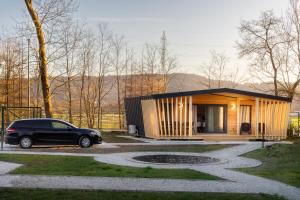 a small house with a car parked in front of it at Pearl of Sava Wild Waters in Ljubljana