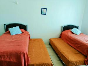 two beds sitting next to each other in a room at Twin Towers Tres Mares in Acapulco