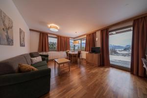 a living room with a couch and a table at Appartement-Edelweiss in Altenmarkt im Pongau