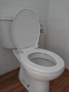 a white toilet with the lid up in a bathroom at Butterworth Seaside view Family spacious in Butterworth
