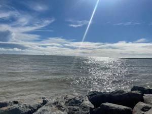 a view of the ocean with rocks in the water at Logis Hôtel Le Rochelois in La Rochelle