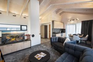 a living room with a couch and a tv at Chalet Pod Brdom - Apartments in Ružomberok