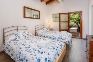 Un dormitorio con dos camas y un espejo. en Finca Es Carregador, en Capdepera 22 fotos más