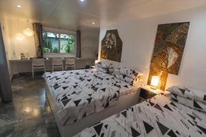 a bedroom with a large bed and a table at The Three P Beach Resort & Dive Center in Romblon