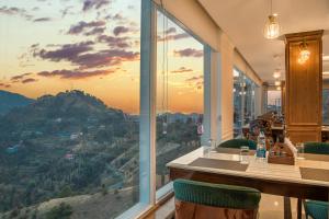 a restaurant with a view of a mountain at AnantVilas Shimla Hills in Shimla