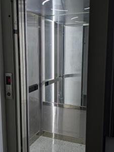 a glass door of a elevator in a building at Welcome Stara Zagora Apartment 4 Guests Pet Friendly in Stara Zagora