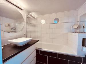 a white bathroom with a sink and a tub at Le Jean -Jaures 2 / Charmant P1 bis in Nîmes