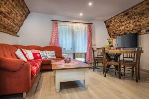 a living room with a couch and a table at Chata Smrekovica in Liptovský Ján