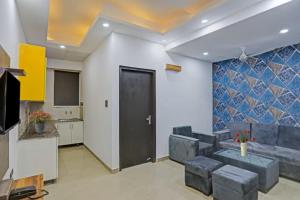 a living room with a couch and a tv at Hotel The RASA at Vasundhara in Ghaziabad