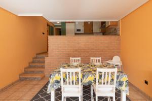 a dining room with a table and four chairs at Saturraran - baskeyrentals in Mutriku