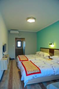 Postel nebo postele na pokoji v ubytování Beidaihe No. 3 Jinhai