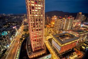 a tall building in a city at night at W Taipei in Taipei