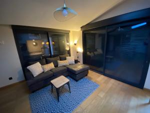 a living room with a couch and a table at Au cœur de la Pinède de 1 à 4 personnes in Langlade