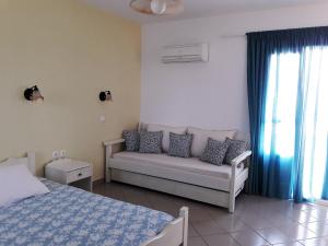 a living room with a couch and a bed at Elpidas studios in Agia Anna Naxos