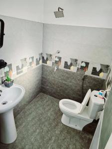 a bathroom with a toilet and a sink at Aloe Vera villa in Negombo +159 photos