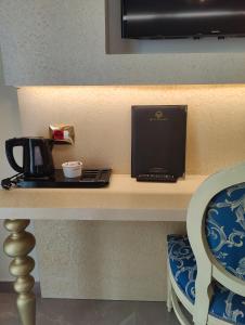 a laptop computer sitting on a desk with a chair at Hotel Ambassador in Rimini