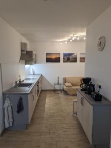 a kitchen with a sink and a stove in a room at Ferienwohnung Am Kleinen Haff in Garz