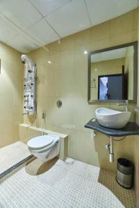 a bathroom with a sink and a toilet and a mirror at Aureole Mrida - A Boutique Hotel in Lonavala
