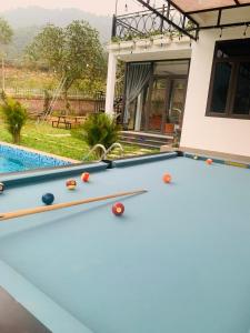 a pool table in front of a house at Cloudy Home - Venuestay in Hanoi