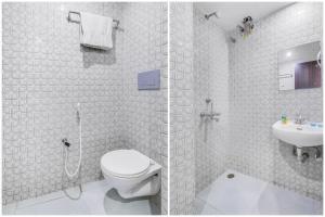 a bathroom with a shower and a toilet and a sink at FabHotel Bhiwandi Palace in Mumbai