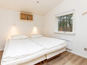 een witte slaapkamer met een groot bed en een raam bij Holiday home Fjerritslev XXIV in Fjerritslev
