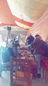 a group of people working at a table in a store at blueskyrum. in Wadi Rum +27 photos