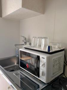Kuchyň nebo kuchyňský kout v ubytování Hostel Belle Via Tokyo