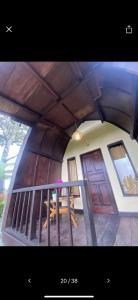 a house with a large wooden ceiling and a door at Pondok Ganesha Bali in Gitgit
