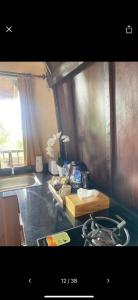 a kitchen with a stove and a counter top at Pondok Ganesha Bali in Gitgit