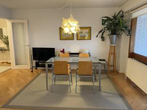 a dining room with a glass table and chairs at Iturrain by smiling rentals in Hondarribia