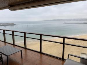 a view of the beach from the balcony of a house at Iturrain by smiling rentals in Hondarribia