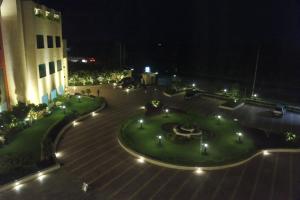 a view of a courtyard at night with a building at Bravura Gold Resort in Meerut