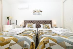 two beds sitting next to each other in a bedroom at Luxe Villa Puerto Banus in Marbella