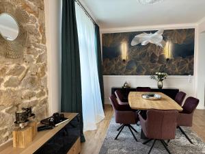 a dining room with a wooden table and chairs at Villa Gloria in Badenweiler