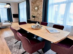 a dining room with a wooden table and chairs at Villa Gloria in Badenweiler