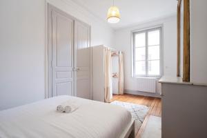 Posteľ alebo postele v izbe v ubytovaní L'Annexe de Stanislas