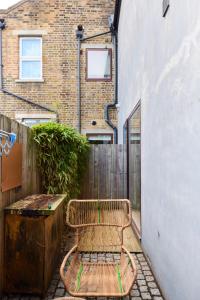 a wooden bench sitting next to a building at The Southwark Wonder - Charming 1BDR Flat with Patio in London