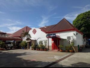 a small white building with a red and white at ARIZONA BEACH RESORT in Olongapo