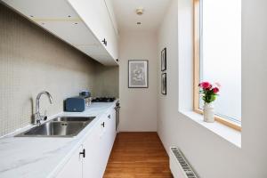 a kitchen with a sink and a window at The Southwark Wonder - Charming 1BDR Flat with Patio in London