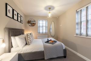 a bedroom with a bed with a tray on it at Elliot Oliver - 2 Bedroom Garden Apartment With Parking in Cheltenham