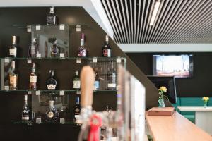 a bar with bottles of alcohol on shelves at Hotel Thermal ŠÍRAVA in Kaluža