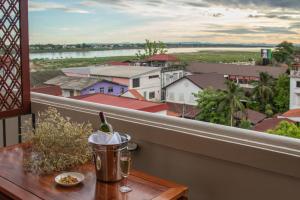 a table on a balcony with a view of a city at Lao Orchid Hotel in Vientiane