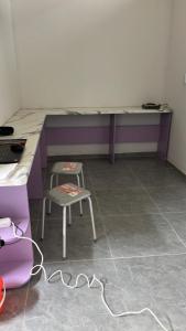 a room with a desk and a chair and a table at Tastaq hostel in Almaty