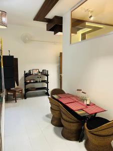 a dining room with a table and some chairs at THE NOOK Nidana Suites in Guwahati
