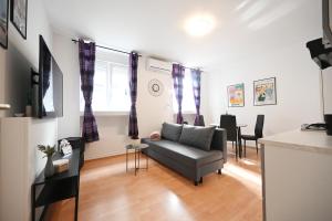 a living room with a couch and a table at Apartment Mia in Zadar