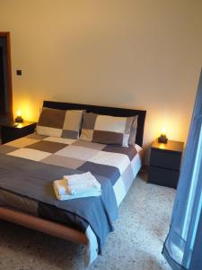 a bedroom with a large bed with two night stands at Picena 177 in Chieti