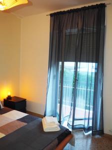 a bedroom with a bed and a large window at Picena 177 in Chieti