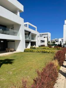 a large white building with a lawn in front of it at Vanian Gardens Apartment -Stella in Estepona